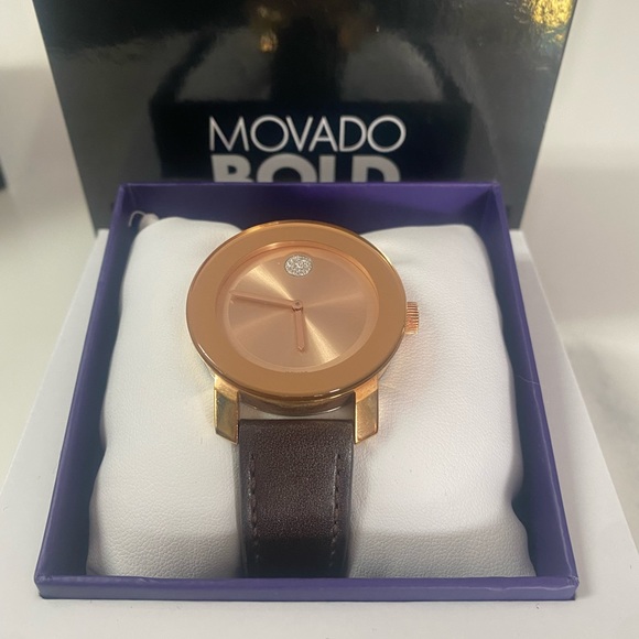 Rose gold face with brown band.